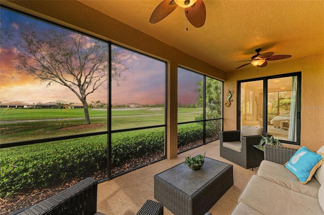 sunroom / solarium featuring ceiling fan