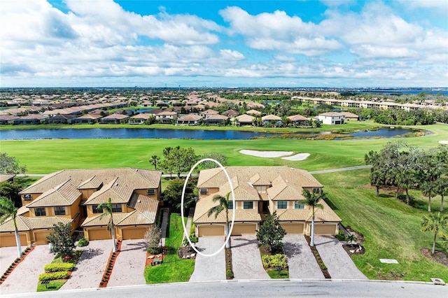 aerial view with a residential view, view of golf course, and a water view