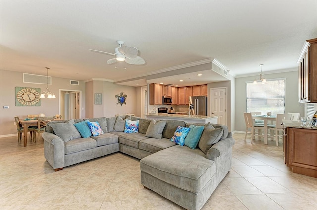 living room with light tile patterned floors, visible vents, and crown molding