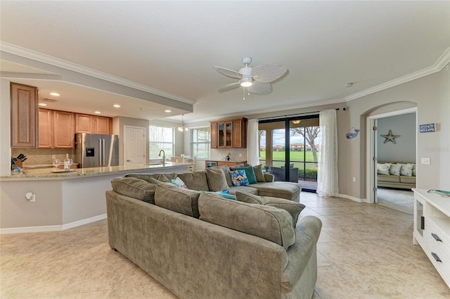 living area featuring recessed lighting, ornamental molding, a ceiling fan, light tile patterned flooring, and baseboards