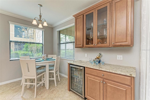 interior space featuring wine cooler, baseboards, pendant lighting, and crown molding