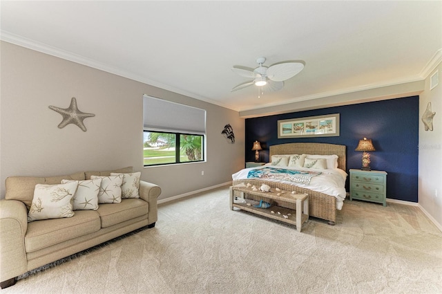 carpeted bedroom with ceiling fan, baseboards, and crown molding