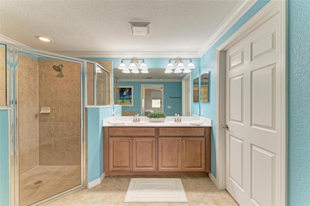 bathroom featuring a shower stall, visible vents, a textured ceiling, and ornamental molding