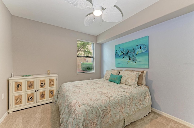 carpeted bedroom with baseboards and a ceiling fan