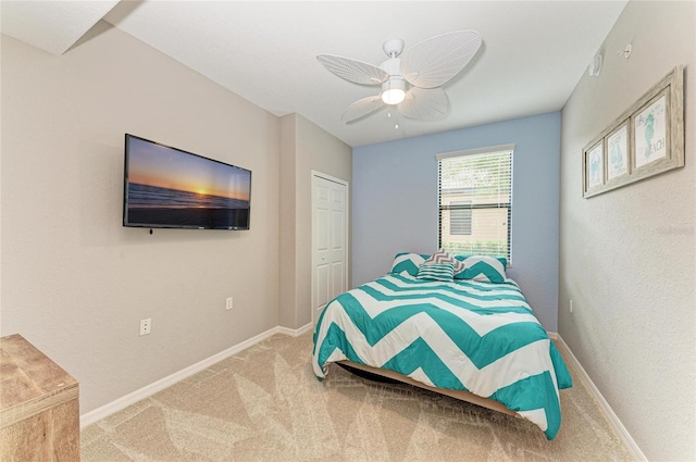 carpeted bedroom featuring ceiling fan and baseboards