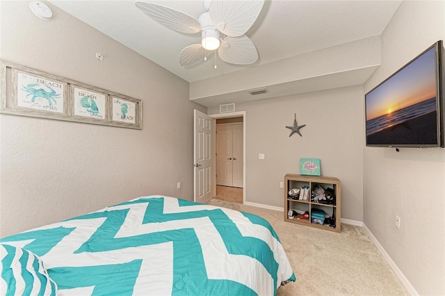 carpeted bedroom with baseboards, visible vents, and a ceiling fan