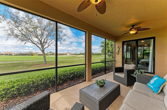 sunroom with a ceiling fan