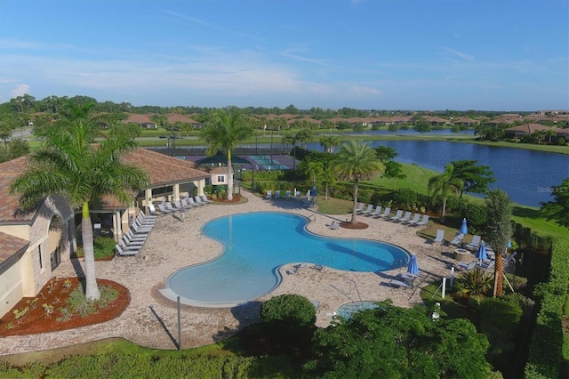 pool featuring a patio area and a water view