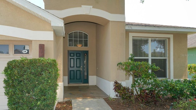 doorway to property with stucco siding