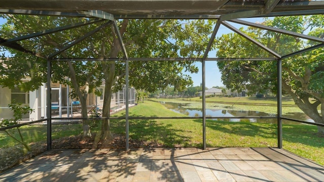 unfurnished sunroom with a water view