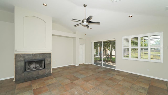 unfurnished living room with baseboards, vaulted ceiling, and a tile fireplace