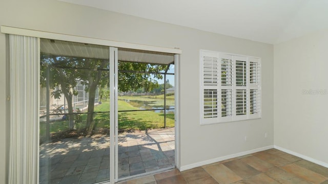 doorway to outside with baseboards