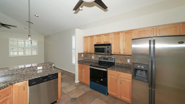 kitchen featuring dark stone counters, a ceiling fan, decorative backsplash, decorative light fixtures, and stainless steel appliances