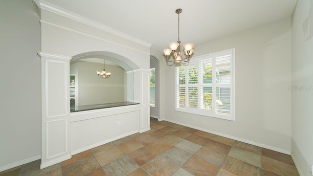 unfurnished room with arched walkways, a notable chandelier, and baseboards