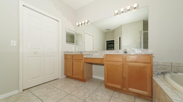 full bath featuring double vanity, a closet, tile patterned floors, a sink, and a bath