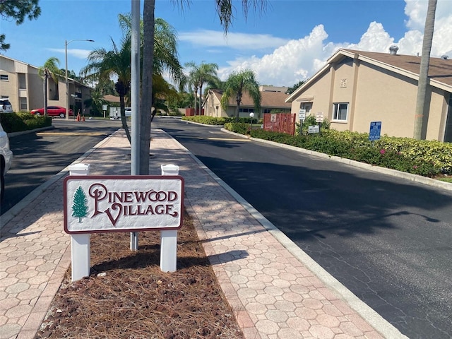 view of road featuring a residential view, curbs, and street lights