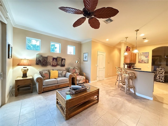 living room with ceiling fan, visible vents, arched walkways, and ornamental molding