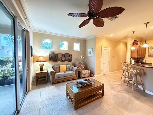 living area featuring baseboards, light tile patterned floors, a ceiling fan, and crown molding