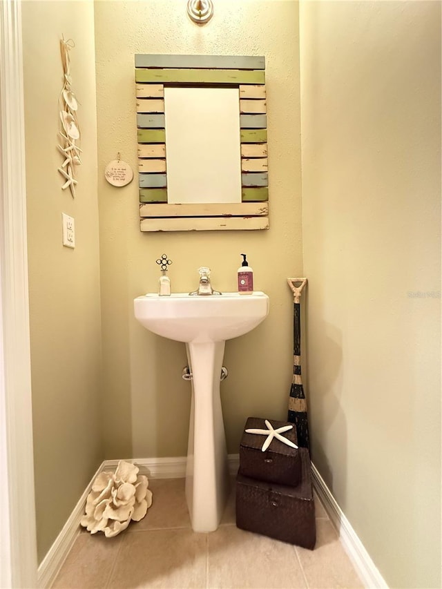 bathroom with tile patterned flooring and baseboards