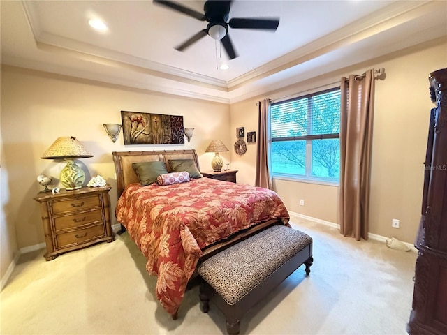 bedroom featuring recessed lighting, light colored carpet, baseboards, a raised ceiling, and crown molding