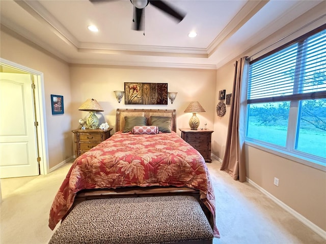 bedroom with a raised ceiling, light colored carpet, crown molding, and baseboards