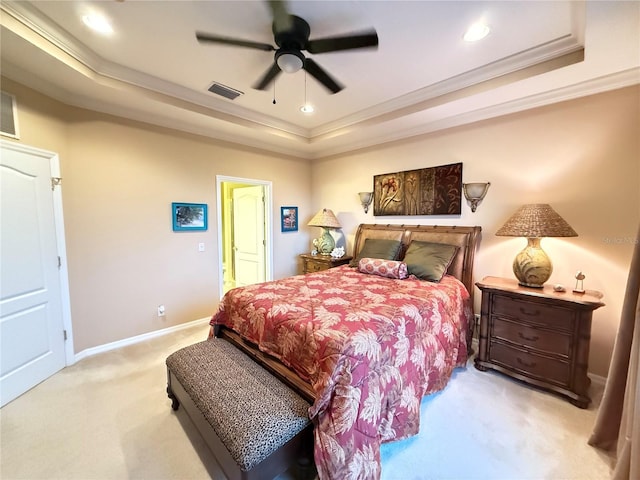 bedroom with crown molding, a raised ceiling, light colored carpet, visible vents, and baseboards