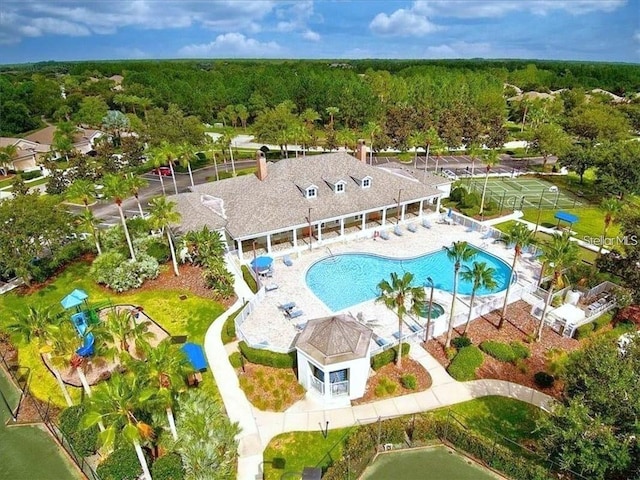 birds eye view of property with a forest view