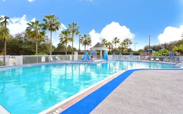 pool with a gazebo and fence