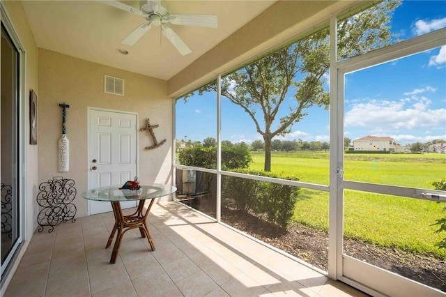 sunroom with visible vents and a ceiling fan