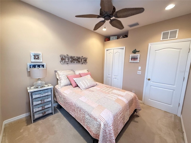 bedroom with light carpet, visible vents, a closet, and recessed lighting