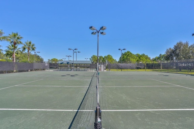 view of sport court featuring fence