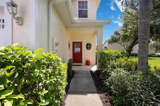 property entrance with stucco siding