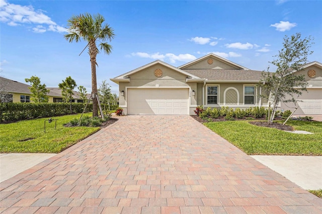 ranch-style house with a garage, a front yard, decorative driveway, and stucco siding