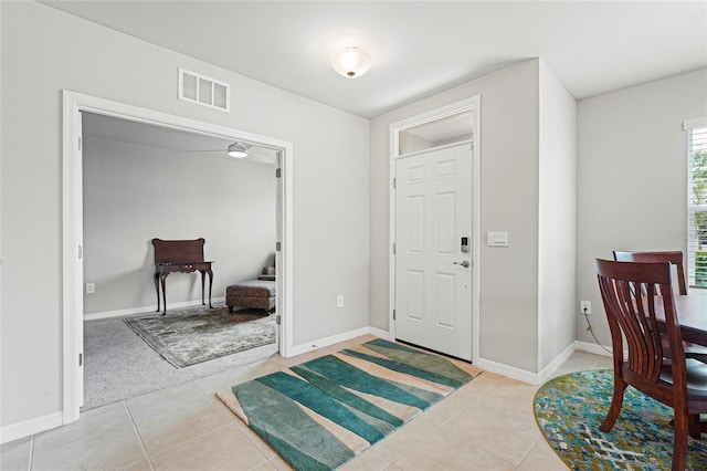 foyer featuring visible vents, baseboards, and light tile patterned floors