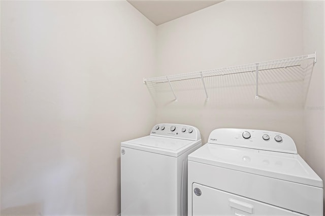 laundry room with laundry area and washing machine and clothes dryer