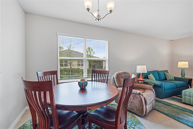 dining room featuring a chandelier, baseboards, and light tile patterned floors