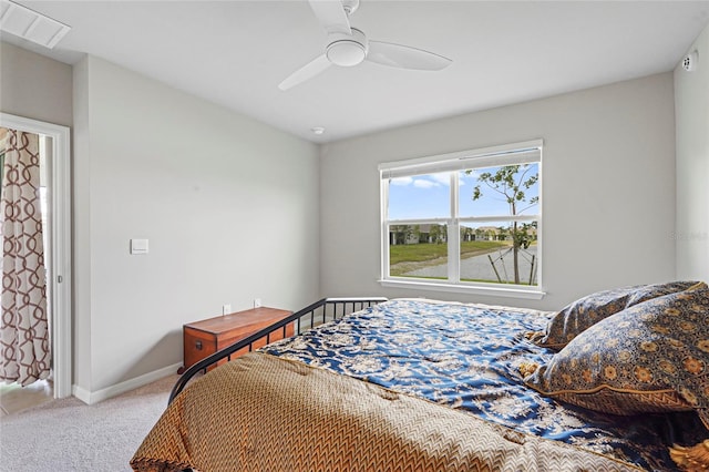 bedroom featuring baseboards, visible vents, ceiling fan, and light colored carpet