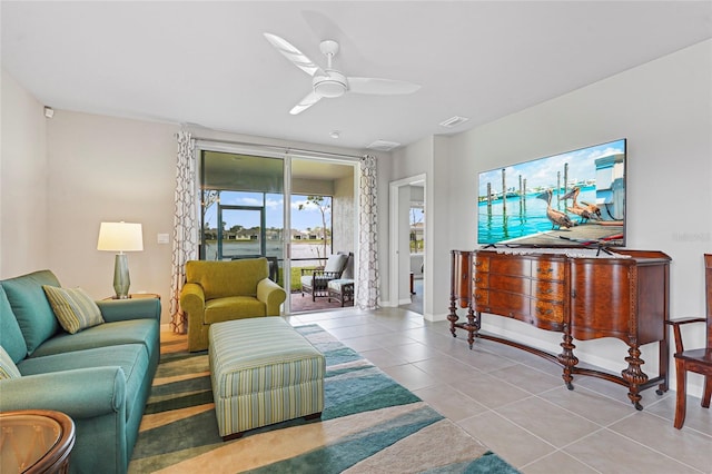 tiled living area with visible vents and a ceiling fan