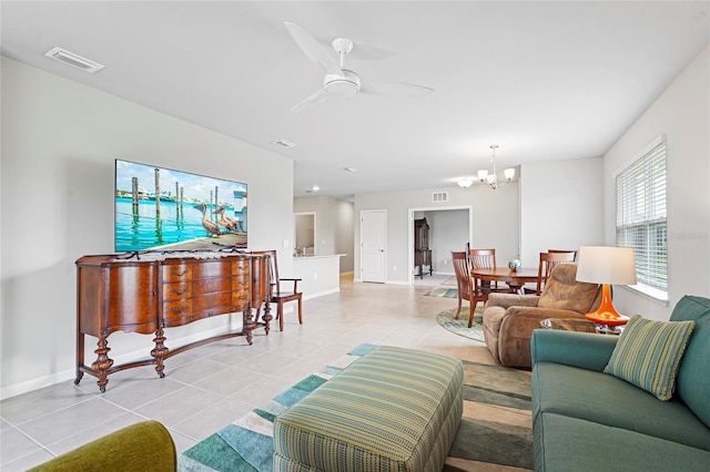 living room with light tile patterned floors, ceiling fan with notable chandelier, and visible vents