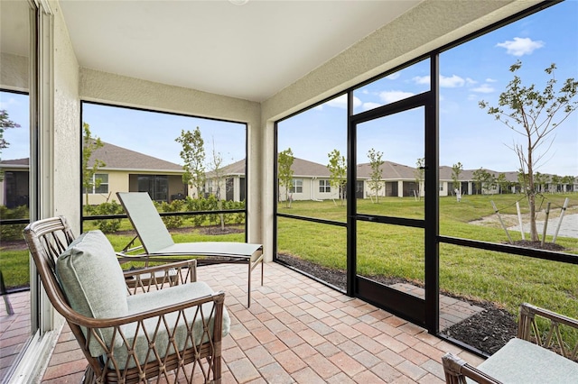 sunroom / solarium featuring a residential view