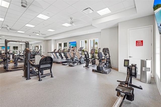 workout area with a drop ceiling, visible vents, and baseboards