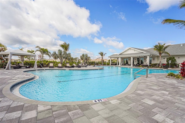 community pool featuring a gazebo and a patio