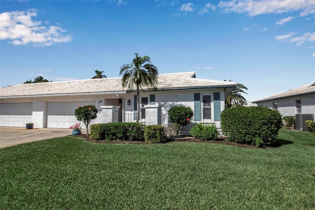 ranch-style house featuring an attached garage, central AC, concrete driveway, stucco siding, and a front lawn