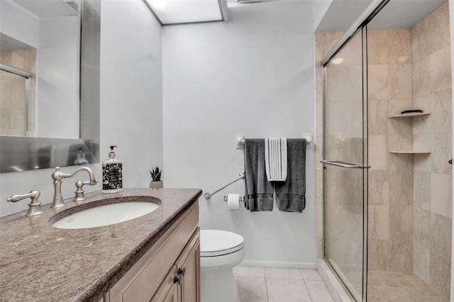 full bath featuring toilet, a stall shower, vanity, tile patterned flooring, and baseboards