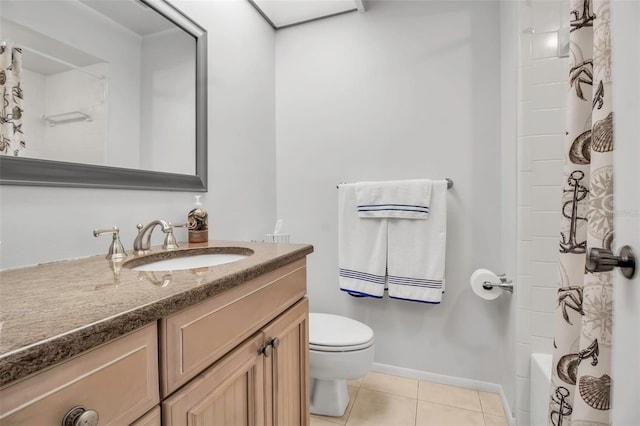 bathroom with toilet, vanity, baseboards, and tile patterned floors