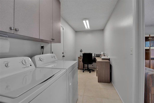 laundry room with cabinet space, light tile patterned flooring, a textured ceiling, washer and dryer, and baseboards