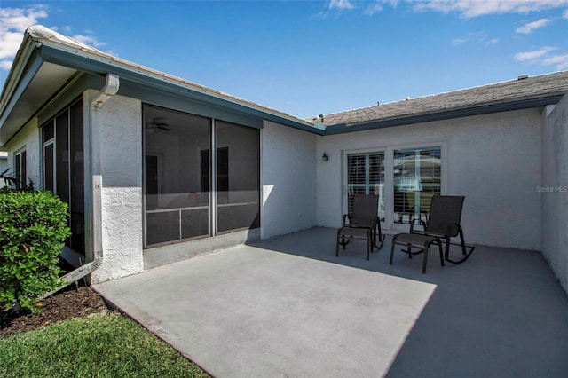 view of patio featuring a sunroom