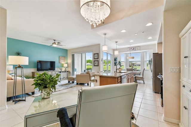 dining space with light tile patterned floors, ceiling fan with notable chandelier, plenty of natural light, and recessed lighting