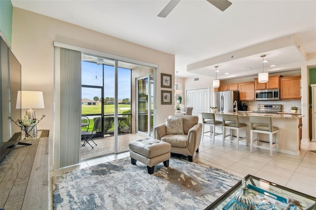 living area with recessed lighting, ceiling fan, and light tile patterned floors