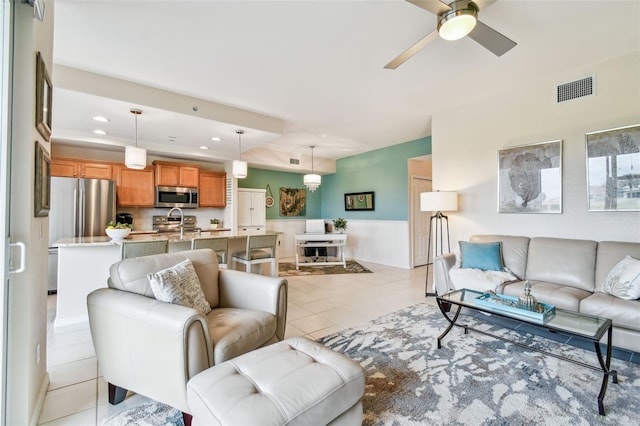 living room featuring light tile patterned floors, recessed lighting, visible vents, a ceiling fan, and wainscoting